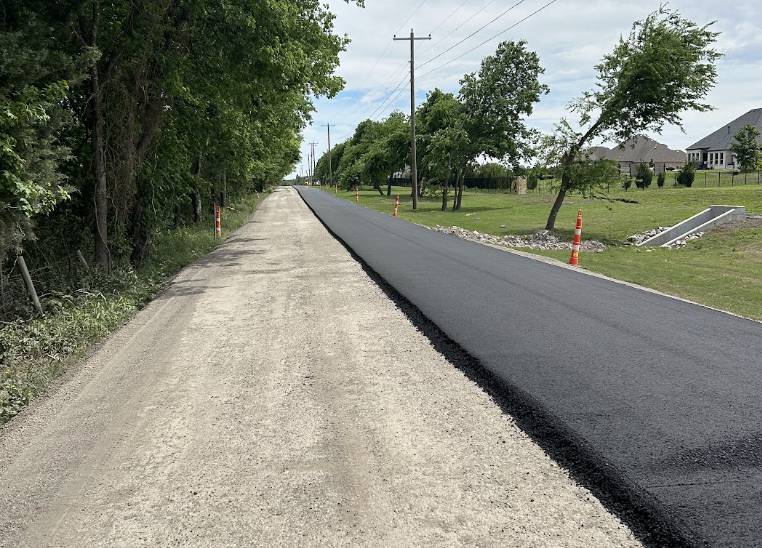 Wirtgen soil stabilizer working on a rural road construction project in Sunnyvale TX by Gentry's Paving Group.
